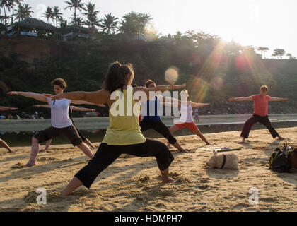 Beach Yoga  at sunrise in Varkala, Kerala, India Stock Photo