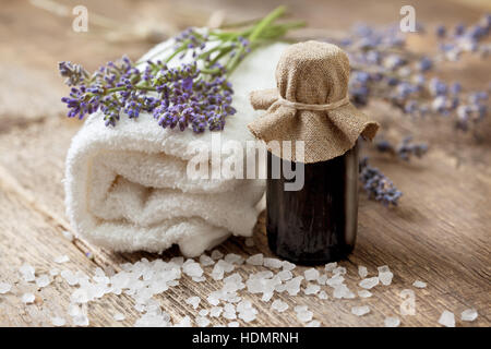 Spa composition: essential oil, lavender, towel on the old wooden background Stock Photo