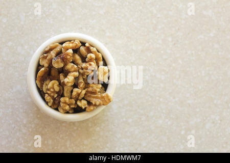 Delicious walnuts in a container on a kitchen countertop, ready to enjoy as a snack or in a favorite recipe! See portfolio for other similar photos in Stock Photo