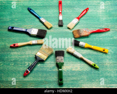 Set of paint brush on green wooden background. Top view Stock Photo