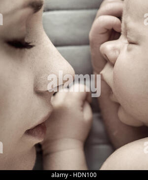 Cute sleeping newborn baby boy with his mother Stock Photo