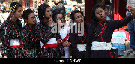 Kathmandu, Nepal. 13th Dec, 2016. Girls from Newar community take a selfie in a parade marking Jyapu Day and Yomari Purnima in Kathmandu, Nepal, Dec. 13, 2016. The Jyapu Day is celebrated every year during the full moon day and Newar community celebrates Yomari Purnima by making Yomari and performing traditional songs and dances. Credit:  Sunil Sharma/Xinhua/Alamy Live News Stock Photo