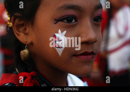 Kathmandu, Nepal. 13th Dec, 2016. A Newari girl particpates in a parade marking Jyapu Day and Yomari Purnima in Kathmandu, Nepal, Dec. 13, 2016. The Jyapu Day is celebrated every year during the full moon day and Newar community celebrates Yomari Purnima by making Yomari and performing traditional songs and dances. Credit:  Sunil Sharma/Xinhua/Alamy Live News Stock Photo