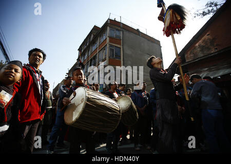 Kathmandu, Nepal. 13th Dec, 2016. Nepalese people dressed in traditional attire take part in a parade to celebrate the Yomari Puni festival in Kathmandu, Nepal on Tuesday, December 13, 2016. A yomari is a confection of rice flour dough, molasses and sesame seeds, shaped like a fish, a most popular food consumed especially on this day in Nepal. The Newar community marks the end of the rice harvest season and worship the Goddess of food and grains for prosperity throughout the year by celebrating the Yomari Puni festival. Credit:  Skanda Gautam/ZUMA Wire/Alamy Live News Stock Photo