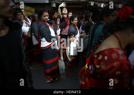 Kathmandu, Nepal. 13th Dec, 2016. Nepalese people dressed in traditional attire take part in a parade to celebrate the Yomari Puni festival in Kathmandu, Nepal on Tuesday, December 13, 2016. A yomari is a confection of rice flour dough, molasses and sesame seeds, shaped like a fish, a most popular food consumed especially on this day in Nepal. The Newar community marks the end of the rice harvest season and worship the Goddess of food and grains for prosperity throughout the year by celebrating the Yomari Puni festival. Credit:  Skanda Gautam/ZUMA Wire/Alamy Live News Stock Photo