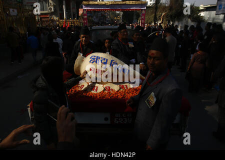 Kathmandu, Nepal. 13th Dec, 2016. A yomari is displayed on top of a vehicle during a parade to celebrate the Yomari Puni festival in Kathmandu, Nepal on Tuesday, December 13, 2016. A yomari is a confection of rice flour dough, molasses and sesame seeds, shaped like a fish, a most popular food consumed especially on this day in Nepal. The Newar community marks the end of the rice harvest season and worship the Goddess of food and grains for prosperity throughout the year by celebrating the Yomari Puni festival. Credit:  Skanda Gautam/ZUMA Wire/Alamy Live News Stock Photo