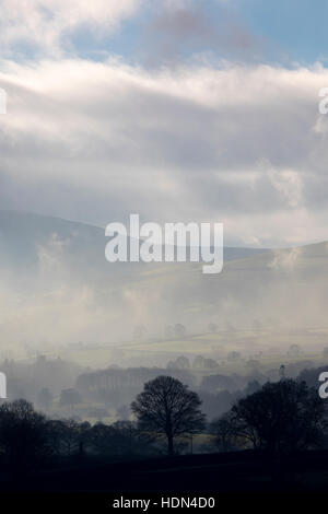 Misty day over the rural Flintshire landscape in North Wales with the Clwydian Range hills just visible in the distance Stock Photo