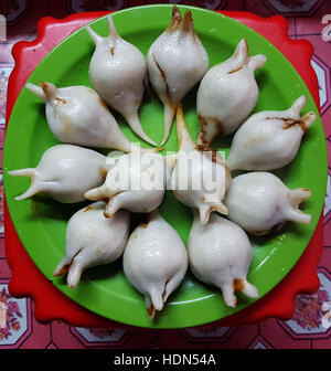 Kathmandu, Nepal. 13th Dec, 2016. Yomaris are served at home on the day of Yomari Punhi in Kathmandu, Nepal, Dec. 13, 2016. Yomari Punhi is a festival especially celebrated by Newar community in Nepal to mark the end of the rice harvest. Yomari is a sweetmeat dough made of rice flour from the new harvest, shaped like fish and filled with brown sugarcane and sesame seeds. Punhi is known as full moon day. © Sunil Sharma/Xinhua/Alamy Live News Stock Photo