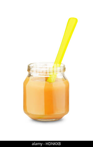 Yellow spoon in jar of baby food isolated on a white background Stock Photo