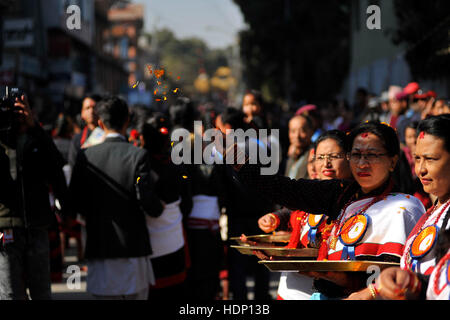 Kathmandu, Nepal. 13th Dec, 2016. People from Newar community, offering flowers to participants during a parade of Yomari Punhi and 13th National Jyapu Diwas, the Newari society organised a rally across the Basantapur Durbar Square, Kathmandu, Nepal on Tuesday, December 13, 2016. The rally reflected several culture and tradition of Newar society. Jatras and festivals are part of life for Newar community. Credit:  Narayan Maharjan/Pacific Press/Alamy Live News Stock Photo