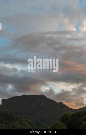 Tuscan hills at sunset. Ponte della Maddalena or Devils Bridge, Borgo a Mozzano, Italy. Has a hydroelectric amenity dam which creates a lake behind. Stock Photo