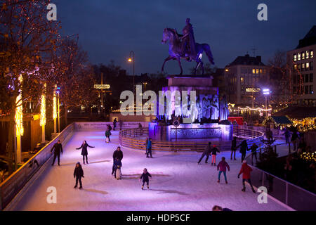 Germany, Cologne, skating rink on the Christmas market at the Heumarkt in the historic town. Stock Photo