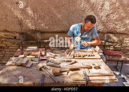 Artist carving the wood in Khiva, Uzbekistan. Stock Photo