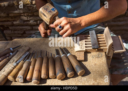 Artist carving the wood. Stock Photo