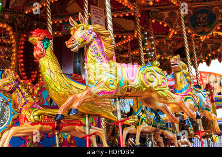 Fairground horses on a traditional carousel at an Easter Bank Holiday fair, London, UK Stock Photo