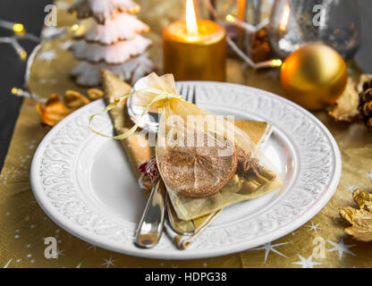 Christmas table setting decoration with festive gift pouch for guests Stock Photo