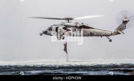 A U.S. Marine special operations soldier climbs a caving ladder on a Sikorsky MH-60 Seahawk helicopter during a helocast training evolution November 28, 2016 in the Indian Ocean.