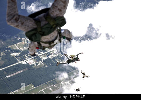 U.S. Marine soldiers conduct a free-fall jump from a Bell Boeing MV-22B Osprey tiltrotor aircraft during parachute exercises above the Marine Corps Base Camp Lejeune Drop Zone Pheasant September 1, 2015 near Jacksonville, North Carolina. Stock Photo