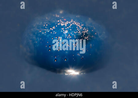 Beautiful micro air bubbles captured in water drops and frozen in ice sparkle in the sun. Closeup macro shot; natural phenomenon Stock Photo