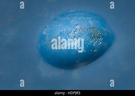 Beautiful micro air bubbles captured in water drops and frozen in ice sparkle in the sun. Closeup macro shot; natural phenomenon Stock Photo