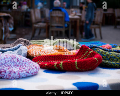 warm wool beanies being sold at a market Stock Photo