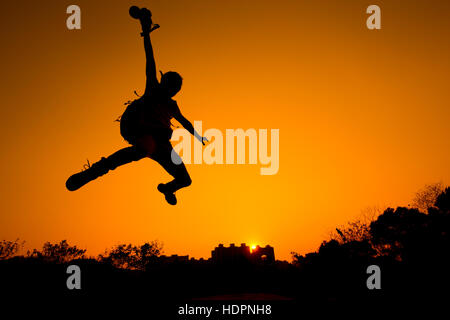 Silhouette of Man jumping - color tone tuned Stock Photo