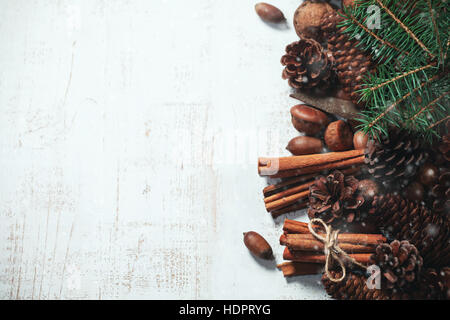 Composition with pine cones and cinnamon sticks on wooden background Stock Photo