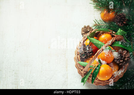 Composition with Tangerines and Pine Cones on Wooden Background Stock Photo