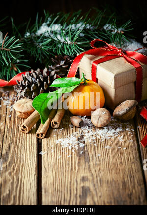 Composition with tangerines, gift, pine cones and spruce Stock Photo