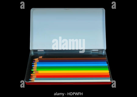 A box of coloured pencils isolated on black, focused on white lid as copy space. Stock Photo