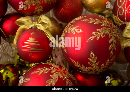 Decorative Christmas balls in a crystal bowl, focused on the positioned-left Christmas tree. Photographed from above. Stock Photo