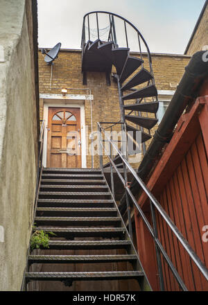 iron staircase to door with spiral iron staircase to roof Stock Photo
