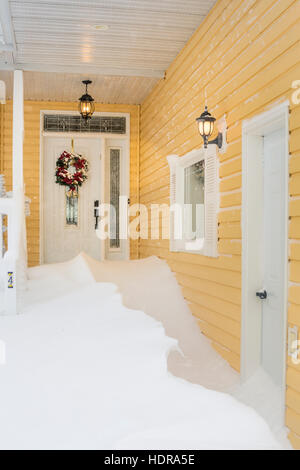 A front entrance door with snow drifts after a blizzard in Winkler, Manitoba, Canada. Stock Photo