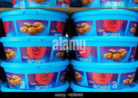Stacked tins of Cadbury Roses chocolates waiting to be sold for Christmas. Stock Photo