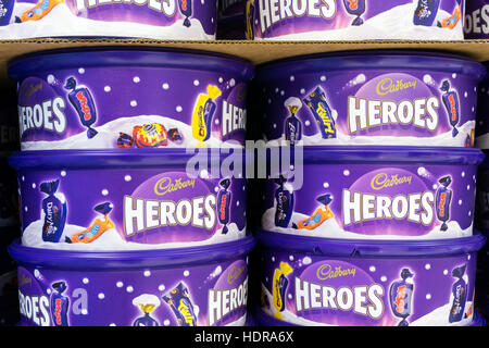 Stacked tins of Cadbury Heroes chocolates waiting to be sold for Christmas.