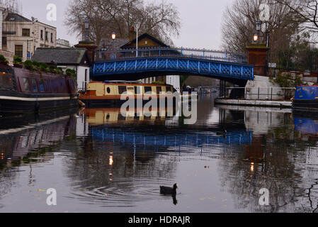 Waterside café barge, bridge and moored barges in Regents Canal Maida Vale, London United Kingdom Stock Photo