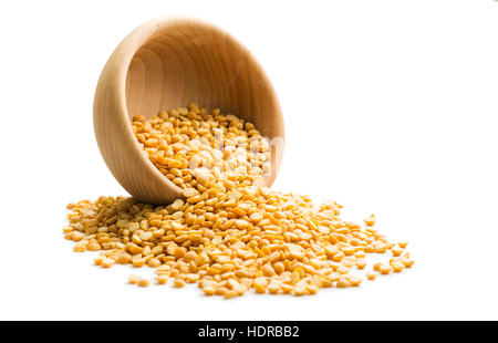 Yellow split peas in wooden bowl isolated on white background. Stock Photo