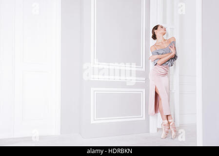 Pretty sporty female standing in ballet pose Stock Photo