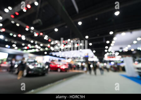 Blurred, defocused background of public event exhibition hall showing cars and automobiles, business commercial event concept Stock Photo