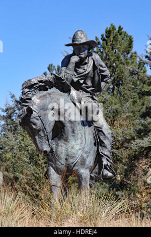 Trail Boss is a sculpture of a horse and rider on Boot Hill in Ogallala Nebraska. He appears to be pondering the graves and town Stock Photo