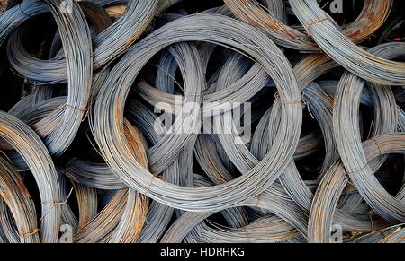 Coils of old galvanized wires with traces of rust Stock Photo