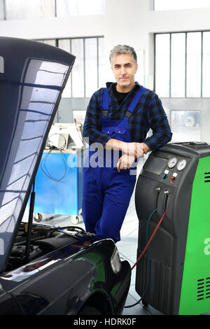 Service car air conditioning. Car air-conditioning, studded coolant . The mechanic fills and fumigation air conditioning in the Stock Photo