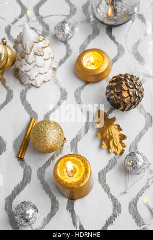 Christmas decorations still-life with candles and ornaments Stock Photo