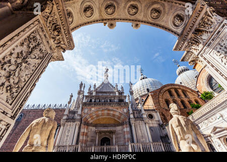 Low angle view looking out towards the chapel and St Mark's Basilica through the courtyard of Doge's Palace, Palazzo Dulce; Venice, Italy Stock Photo