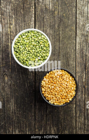 Green and yellow split peas in bowl. Top view. Stock Photo