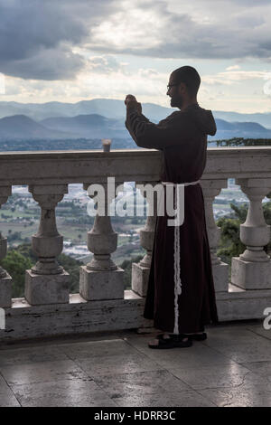 A young monk photographs from the balcony of оne of most known Abbeys in the world the Abbey of Montecassino, , Italy Stock Photo