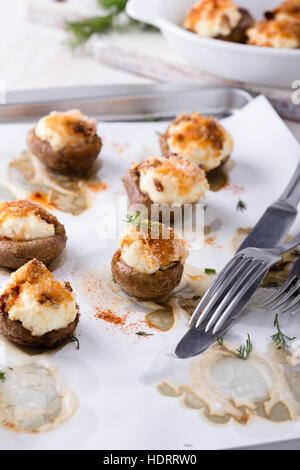 Homemade goat cheese stuffed mushrooms on baking sheet Stock Photo