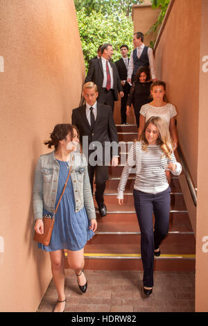 Formally dressed multiracial teens and parents march to church to participate in Confirmation mass at a Laguna Niguel, CA, Catholic church. Note formal white dress. Stock Photo
