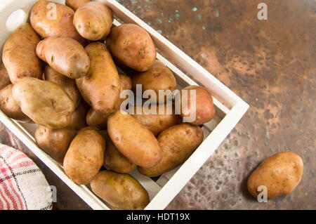 raw washed whole potatoes in a basket Stock Photo