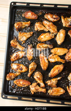 bbq chicken wings on a black baking plate Stock Photo
